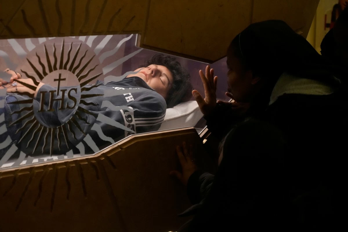 FILE - The body of Carlo Acutis, an Italian boy who died in 2006 of leukemia, lies in his tomb in Assisi, Italy, on Saturday, March 1, 2025. (AP Photo/Gregorio Borgia, file)