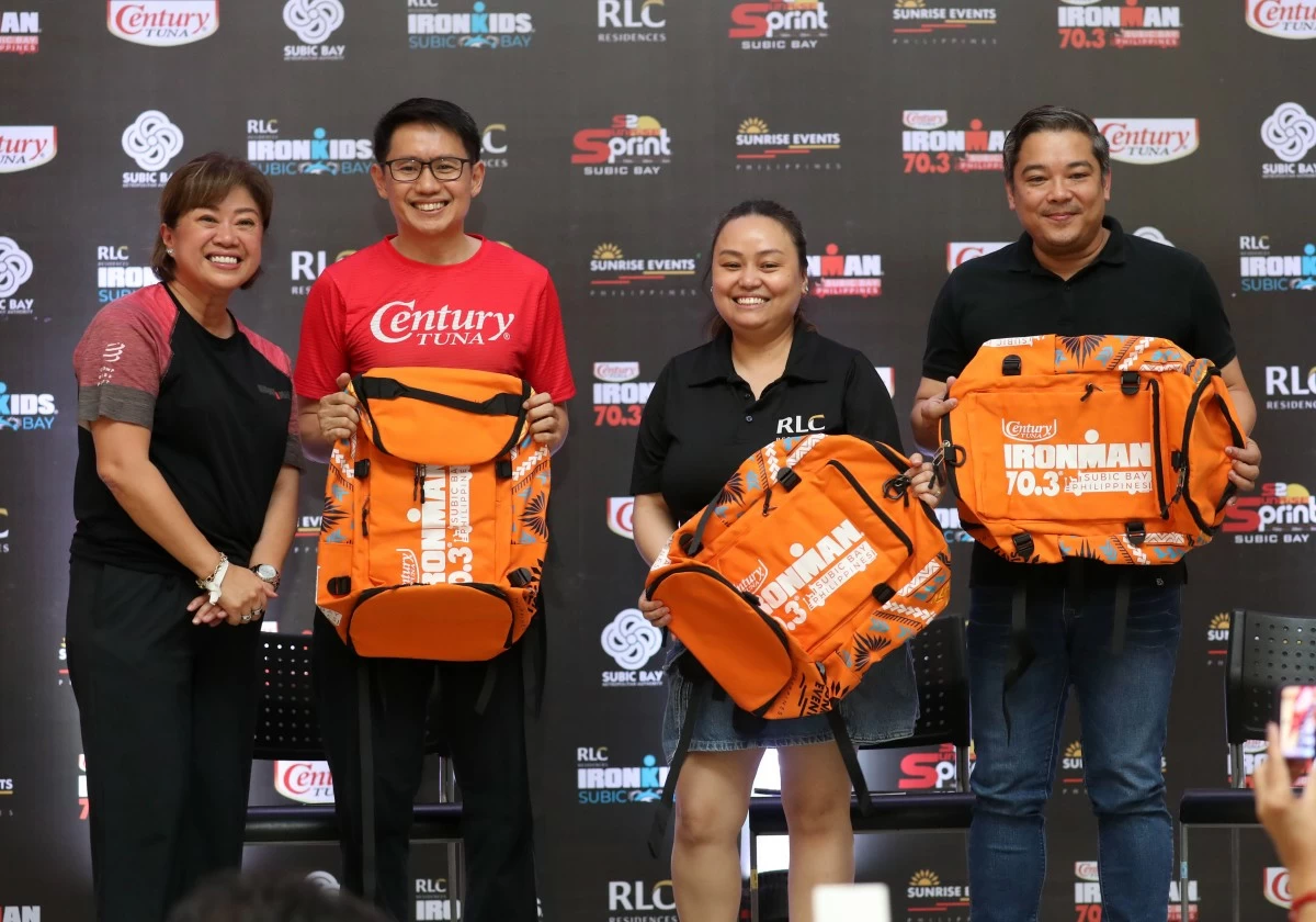 Officials of Century Tuna, RLC Residences and Subic Bay Management Authority share a light moment while showcasing the IRONMAN 70.3 Subic souvenir bags during the press launch of the event on Saturday. From left are Sunrise Events, Inc. president and general manager Princess Galura; Carlo Endaya, vice president and general manager of Century Tuna and Vita Coco, RLC Residences marketing head and chief Integration officer Karen Cesario, and SBMA chief of staff Atty. Von Rodriguez.