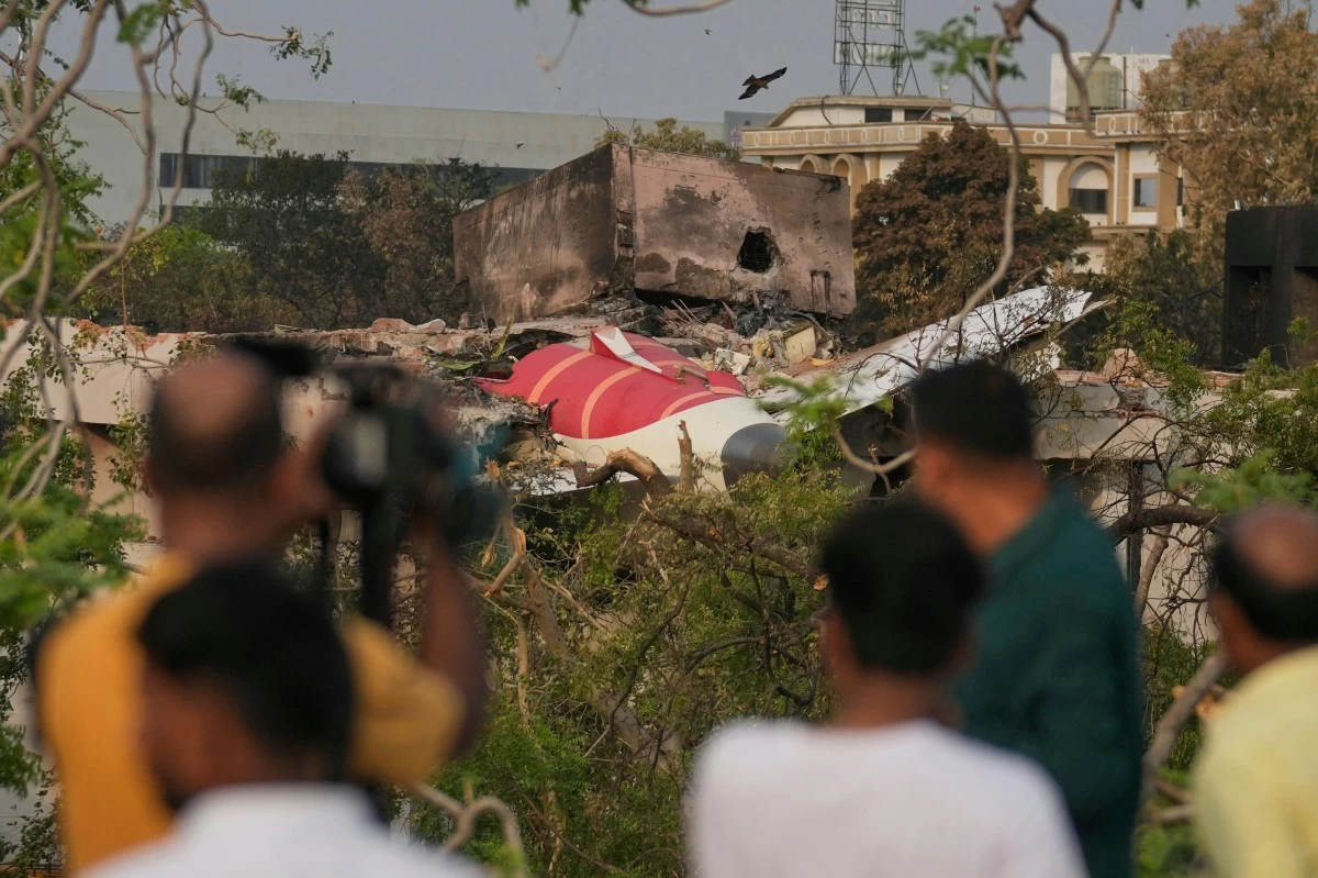ONLOOKERS watch wreckage from Thursday's Air India plane crash lying atop a building in Ahmedabad, India, Saturday, June 14, 2025. (AP)