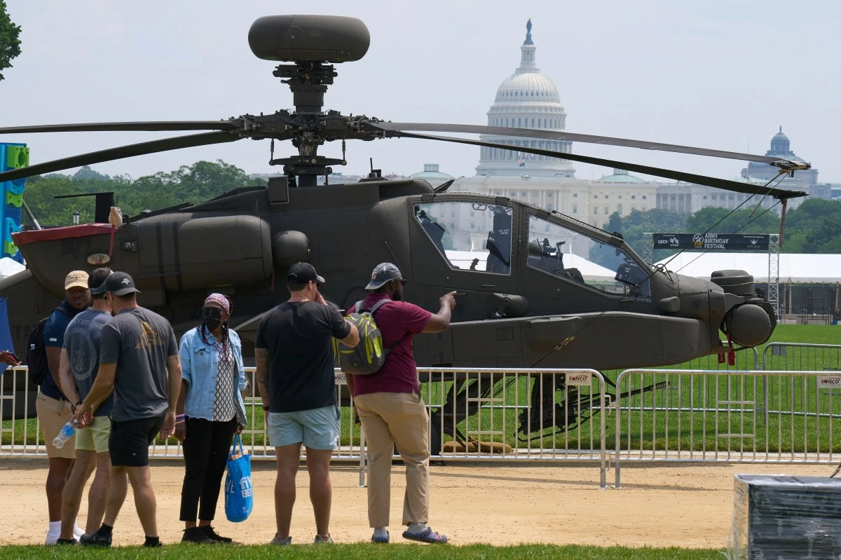 PEOPLE look at a military helicopter with the Capitol in the background, Friday, June 13, 2025, on the National Mall in Washington, during preparations for an upcoming military parade commemorating the Army's 250th anniversary and coinciding with President Donald Trump's 79th birthday. (AP)
