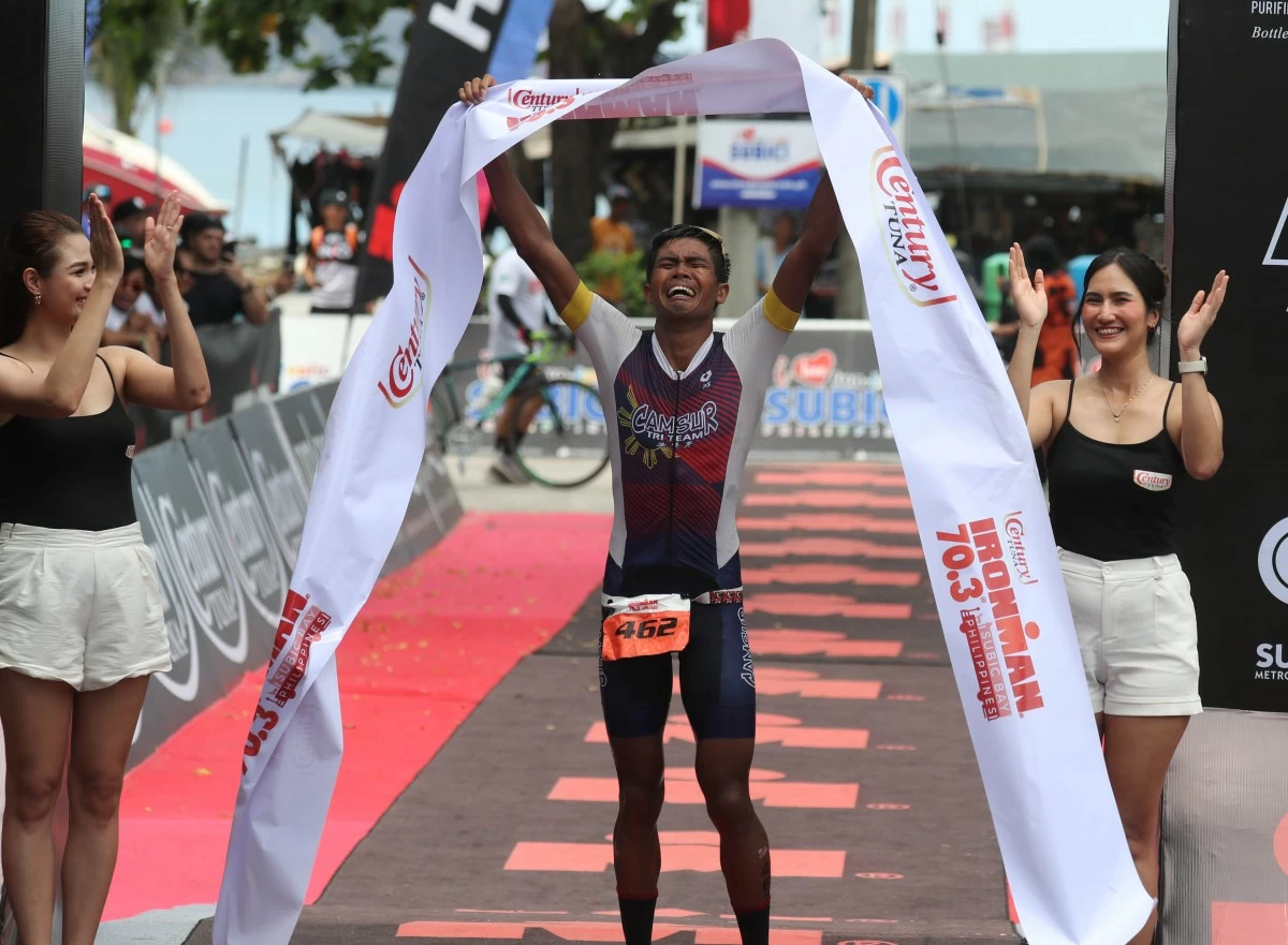 Overcome with emotion, John Patrick Ciron fights back tears as he crosses the finish line of the Century Tuna IRONMAN 70.3 Subic Bay, conquering a grueling test of will and endurance to seize a storybook 70.3 race win on his first try.