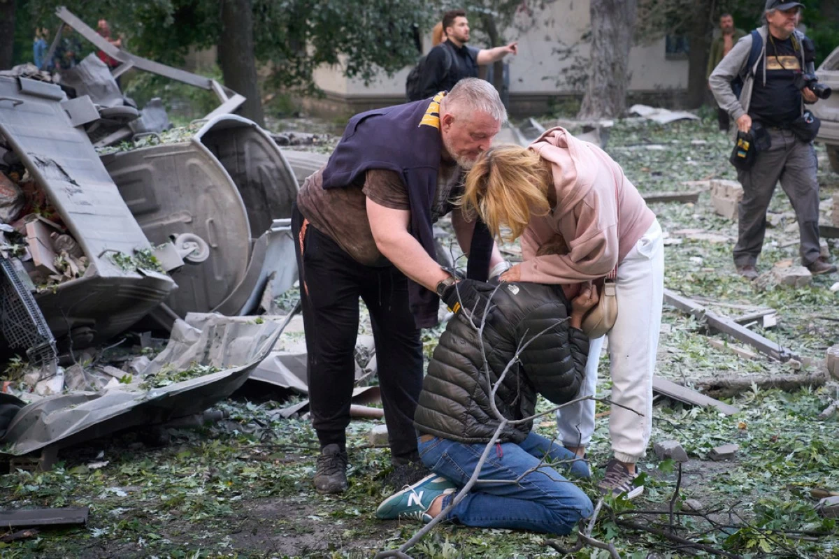 Residents react after a Russian missile hit a multi-storey apartment during Russia's massive missile and drone air attack in Kyiv, Ukraine, Tuesday, June 17, 2025. (AP Photo/Efrem Lukatsky)