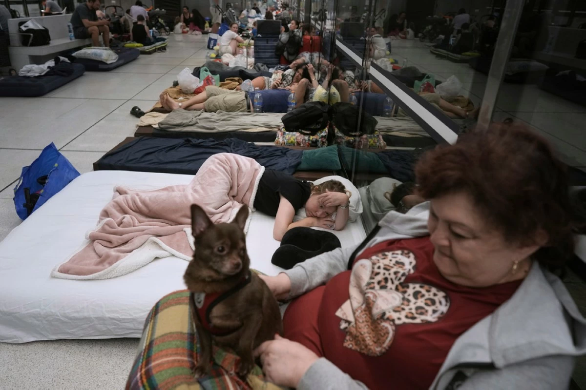 People take shelter in an underground metro station as a precaution against possible Iran missile attacks, in Ramat Gan, near Tel Aviv, Israel, Tuesday, June 17, 2025. (AP Photo/Oded Balilty)