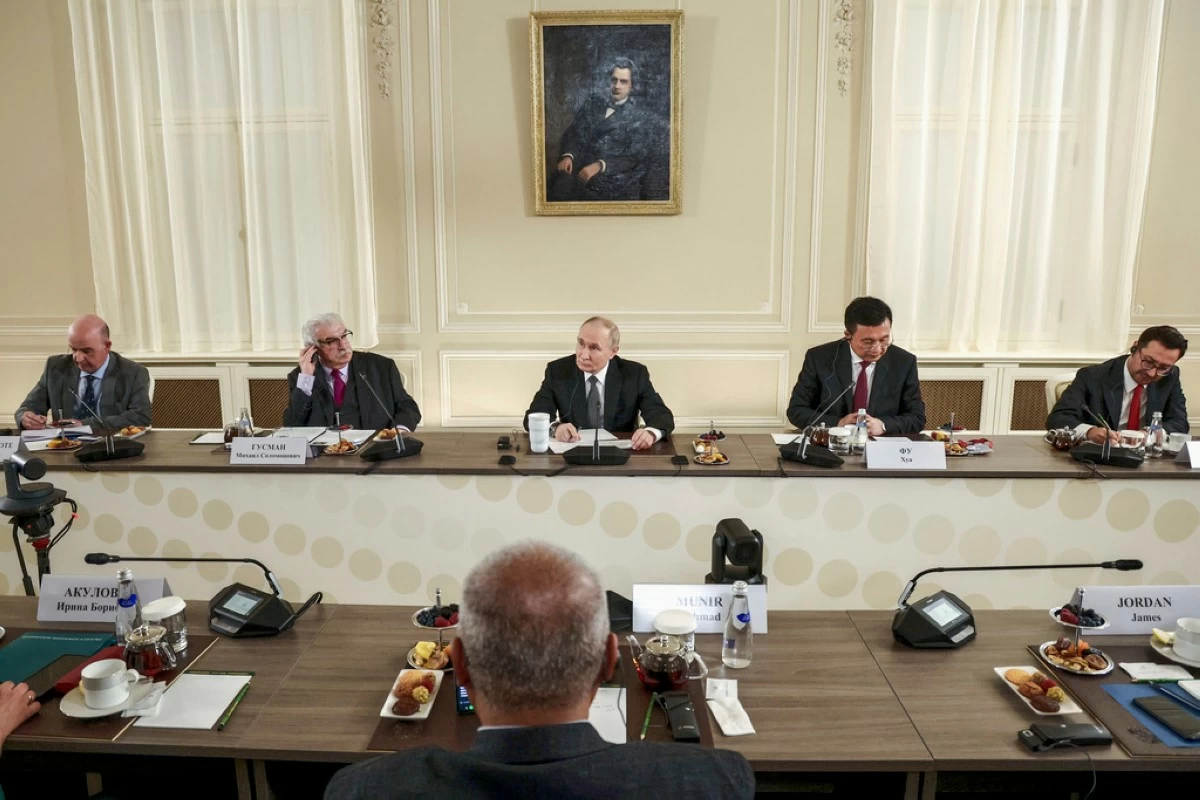 Russian President Vladimir Putin, center, meets with the heads of international news agencies at the newly renovated St. Petersburg Rimsky-Korsakov State Conservatory on the sidelines of the St. Petersburg International Economic Forum in St. Petersburg, Russia, Wednesday, June 18, 2025. (Vyacheslav Prokofyev, Sputnik, Kremlin Pool Photo via AP)