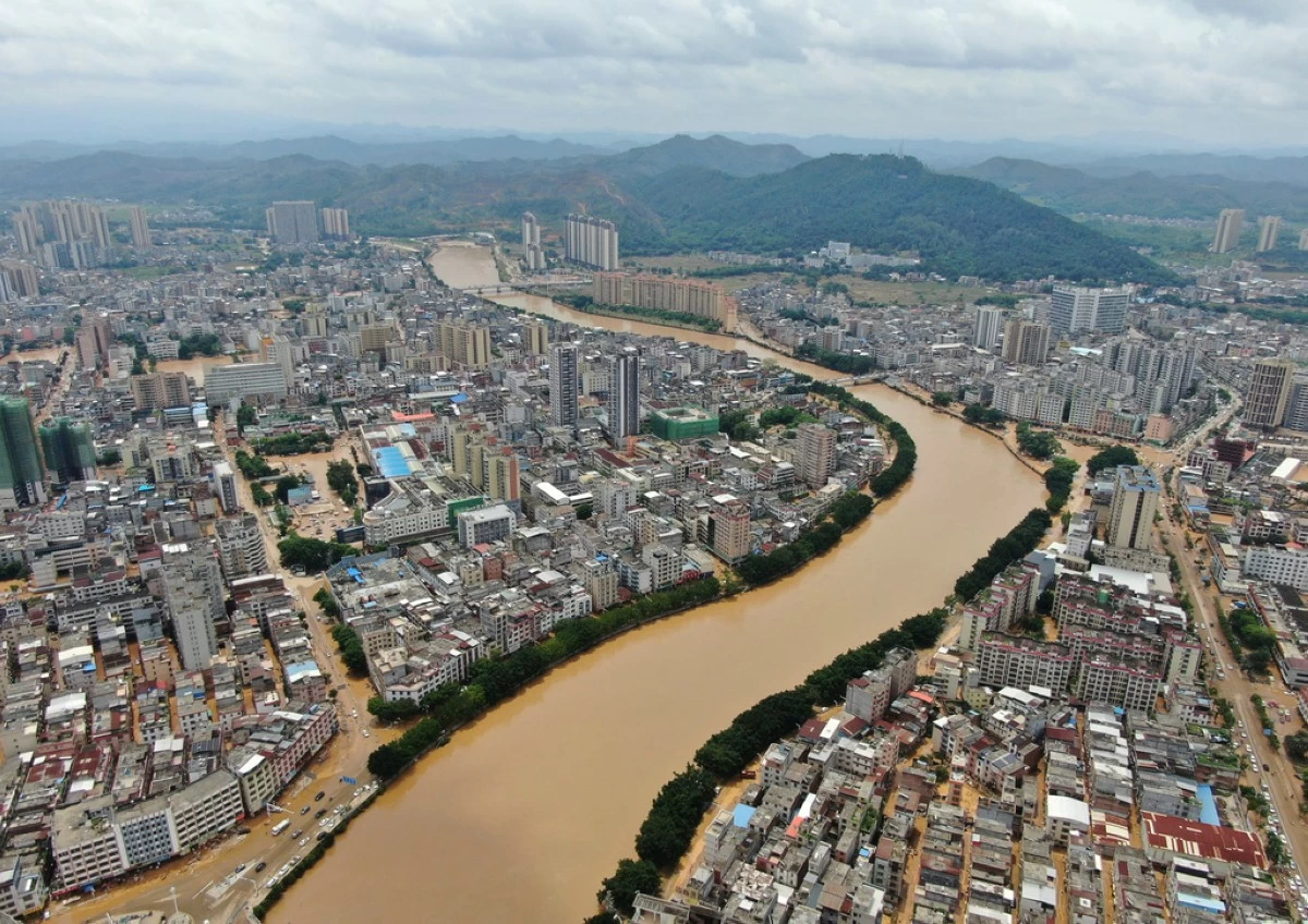 In this photo released by Xinhua News Agency, an aerial view show floodwaters from a river overwhelmed towns following days of heavy rain, in Huaiji County, south China's Guangdong Province on June 19, 2025. (Deng Hua/Xinhua via AP)