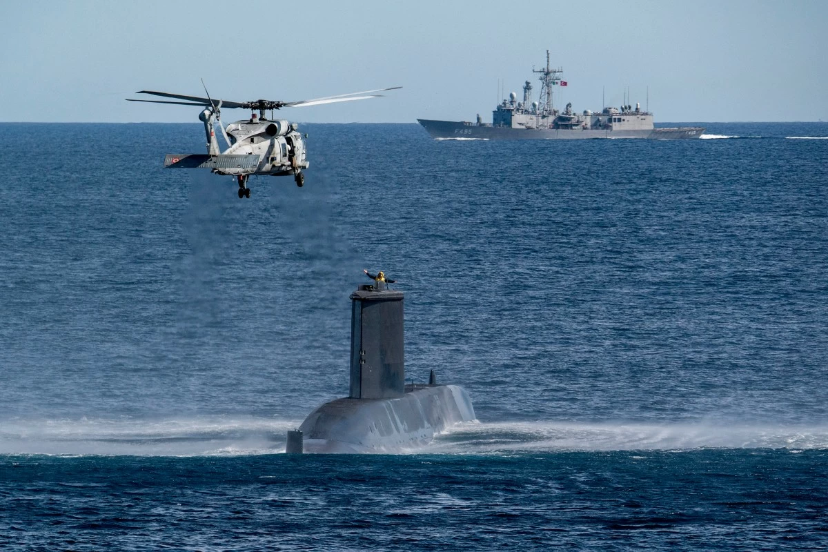 FILE - A Turkish navy helicopter, ship and submarine take part in a warfare exercise off the coast of Catania, Sicily, southern Italy, Monday, Feb. 26, 2024. (AP Photo/Salvatore Cavalli, File)