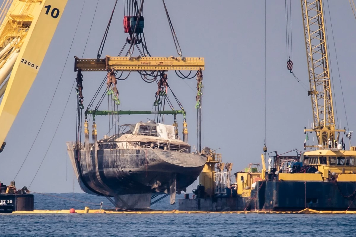 The hull of the superyacht Bayesian, which sank near Palermo, Sicily, on Aug,. 19, 2024, is pulled out of the sea off the village of Porticello and dewatered, Saturday, June 21, 2025. (AP Photo/Salvatore Cavalli)