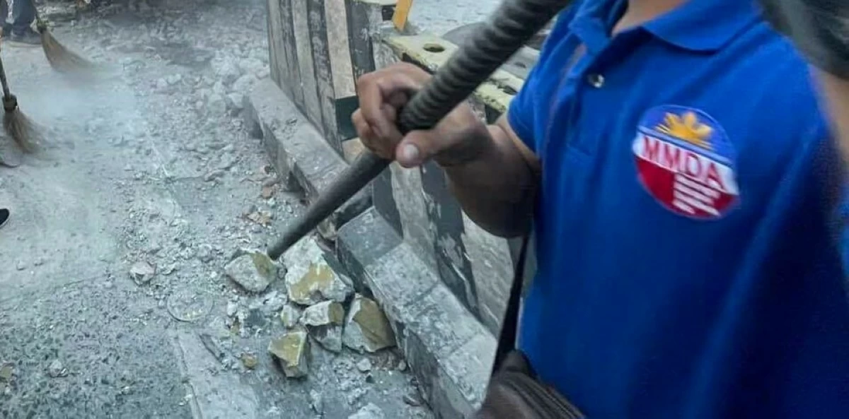 [File photo] Members of the MMDA Road Emergency Group clear debris from a provincial bus involved in an accident along the northbound lane of the EDSA-Santolan flyover in Quezon City on April 30, 2024. (Photo by Mark Balmores)