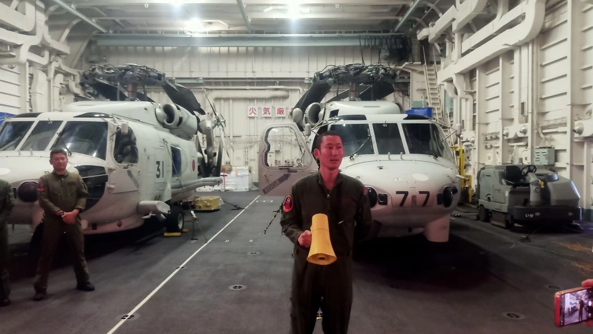 A Japan Maritime Self-Defense Force (JMSDF) personnel briefs the media at the hangar of Japanese destroyer JS Ise while she was docked at Pier 15 in Port Area, Manila on June 21, 2025. Shown behind are two SH-60K Seahawk helicopters. (Photo: Martin A. Sadongdong / MANILA BULLETIN)
