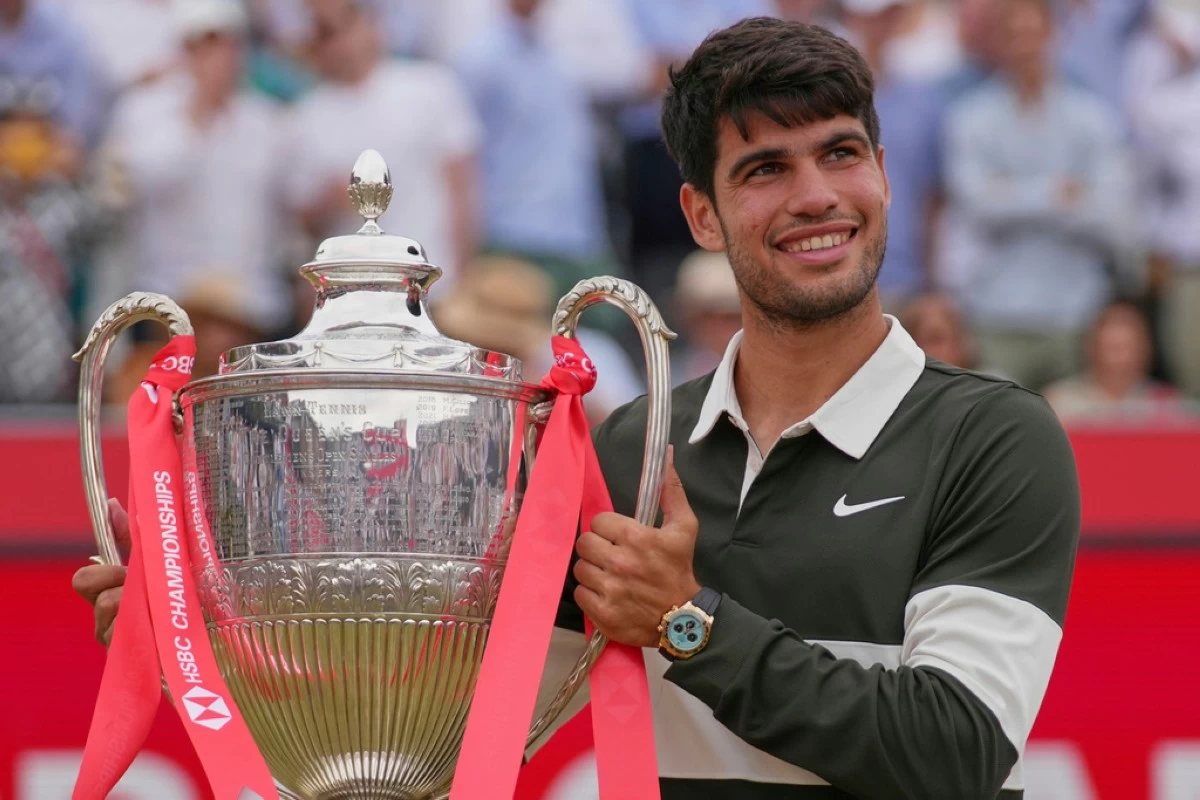 Carlos Alcaraz of Spain looks up as he holds up the winners trophy after defeating Jiri Lehecka of the Czech Republic, in the men's singles final of the Queens Club tennis championships in London, Sunday, June 22. (AP Photo/Joanna Chan)