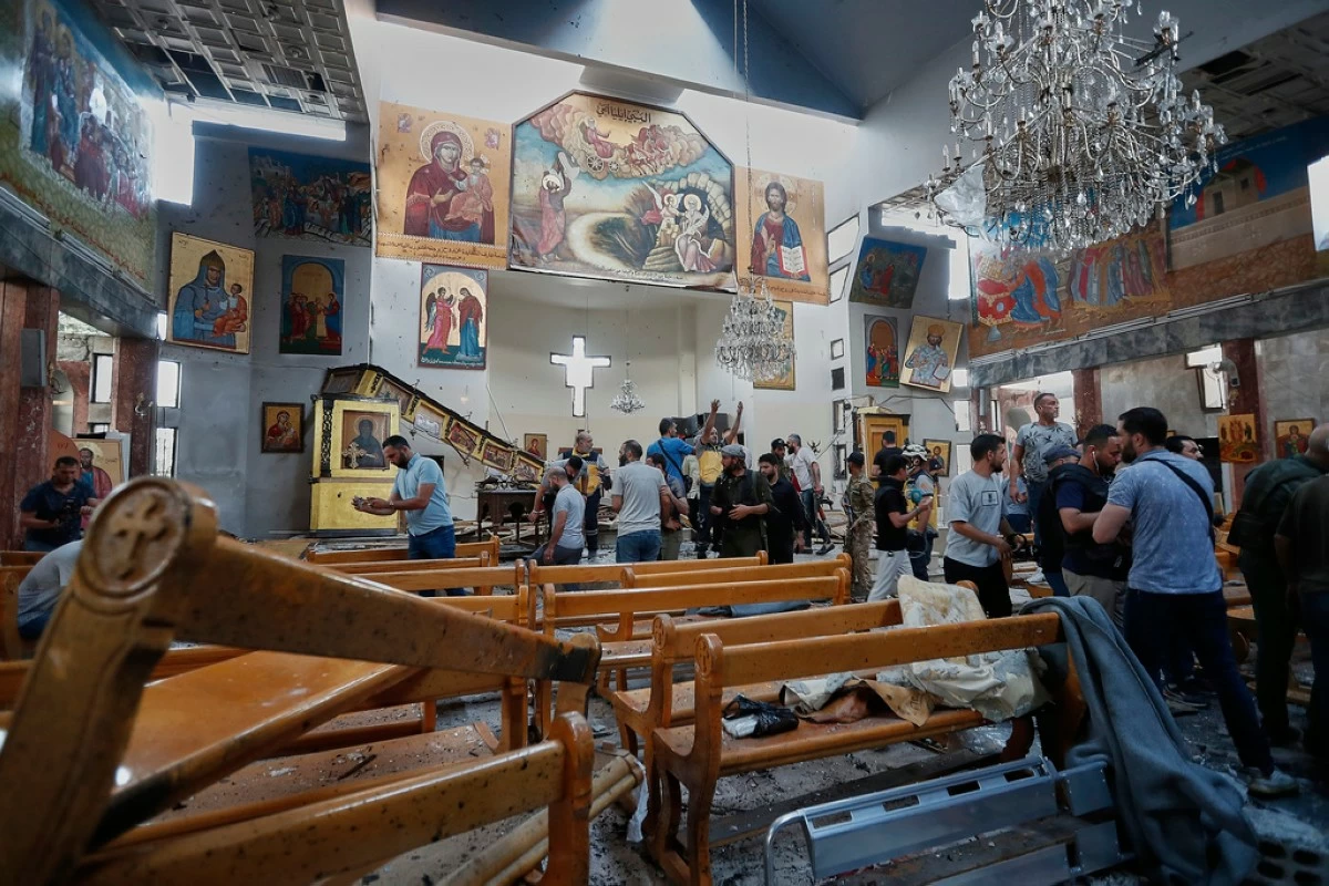 Syrian citizens and security forces inspect the damage inside Mar Elias church where a suicide bomber detonated himself in Dweil'a in the outskirts of Damascus, Syria, Sunday June 22, 2025. (AP Photo/Omar Sanadiki)
