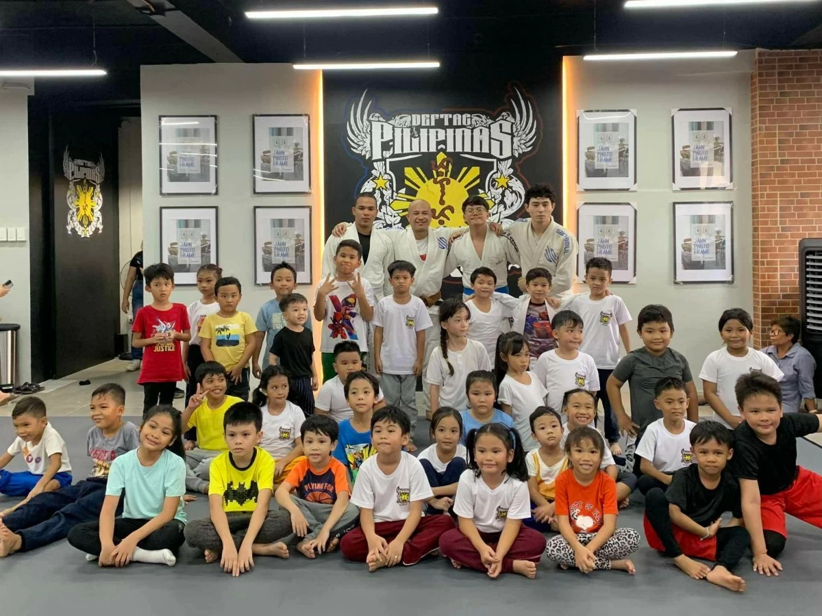 Kids pose for a group photo after training in Deftac