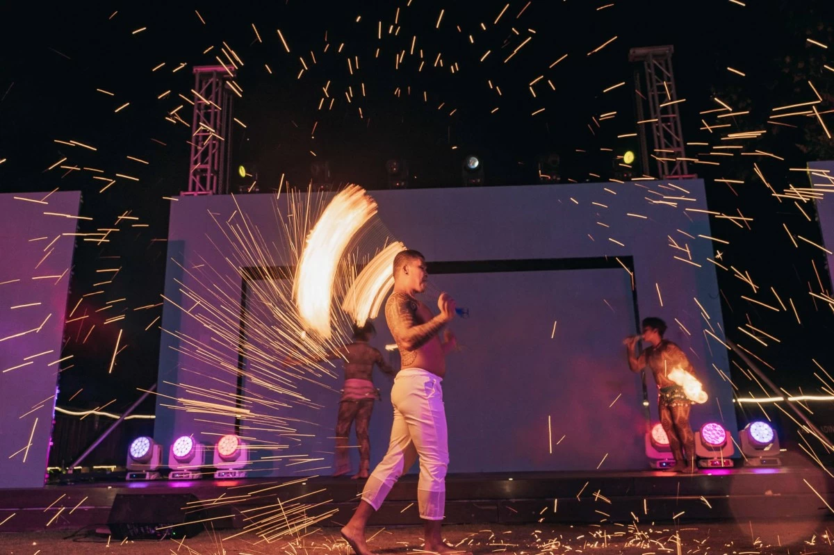 A thrilling fire dance performance lights up the beachside stage during the evening socials of the 11th NSC