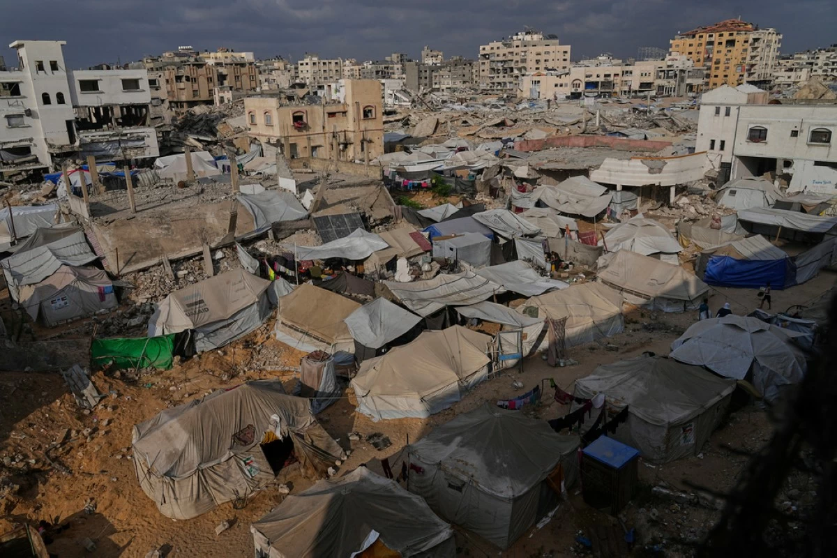Displaced Palestinians live in a tent camp in Gaza City, Monday, June 23, 2025. (AP Photo/Jehad Alshrafi)