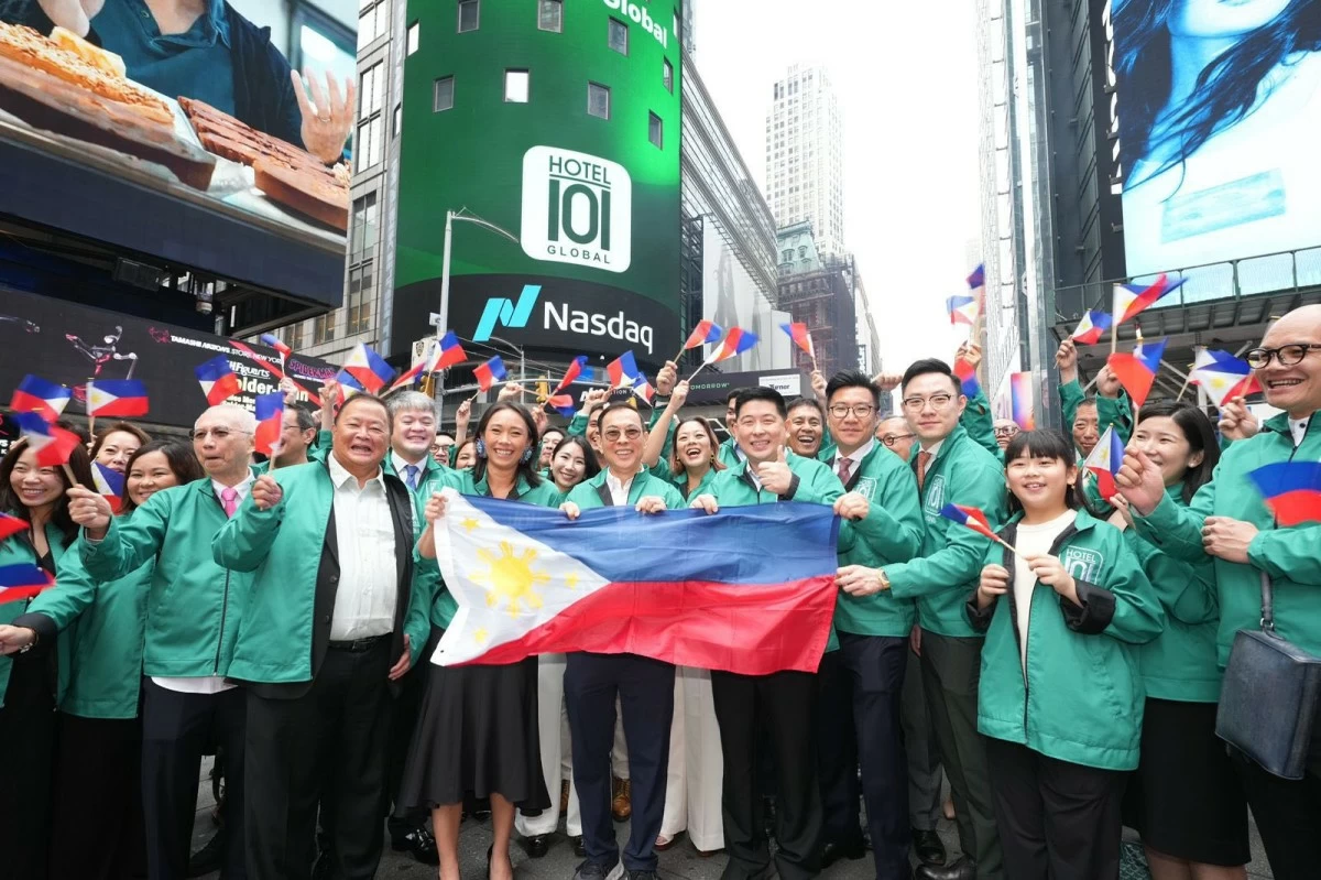 Hotel101 CEO Hannah Yulo-Luccini, and Founders Tony Tan Caktiong and Edgar Sia II, celebrate their landmark Nasdaq listing by proudly displaying the Philippine flag outside the Nasdaq building in New York City.
