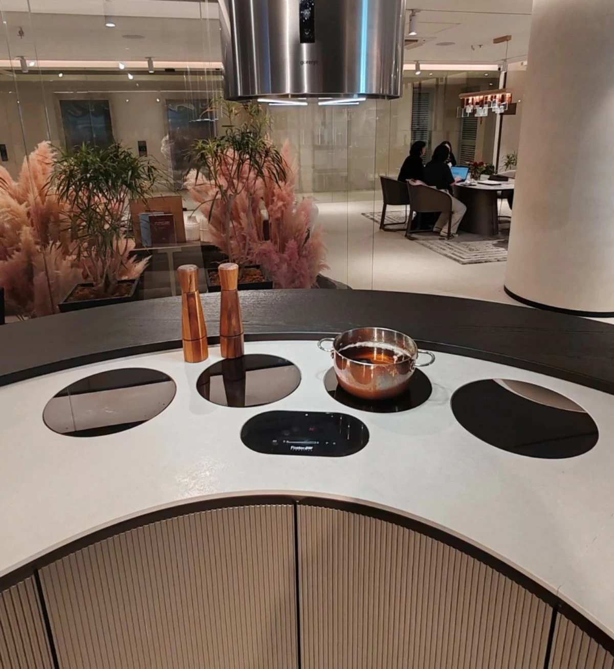 The curved kitchen table can be fitted with stoves, sinks, and accessories