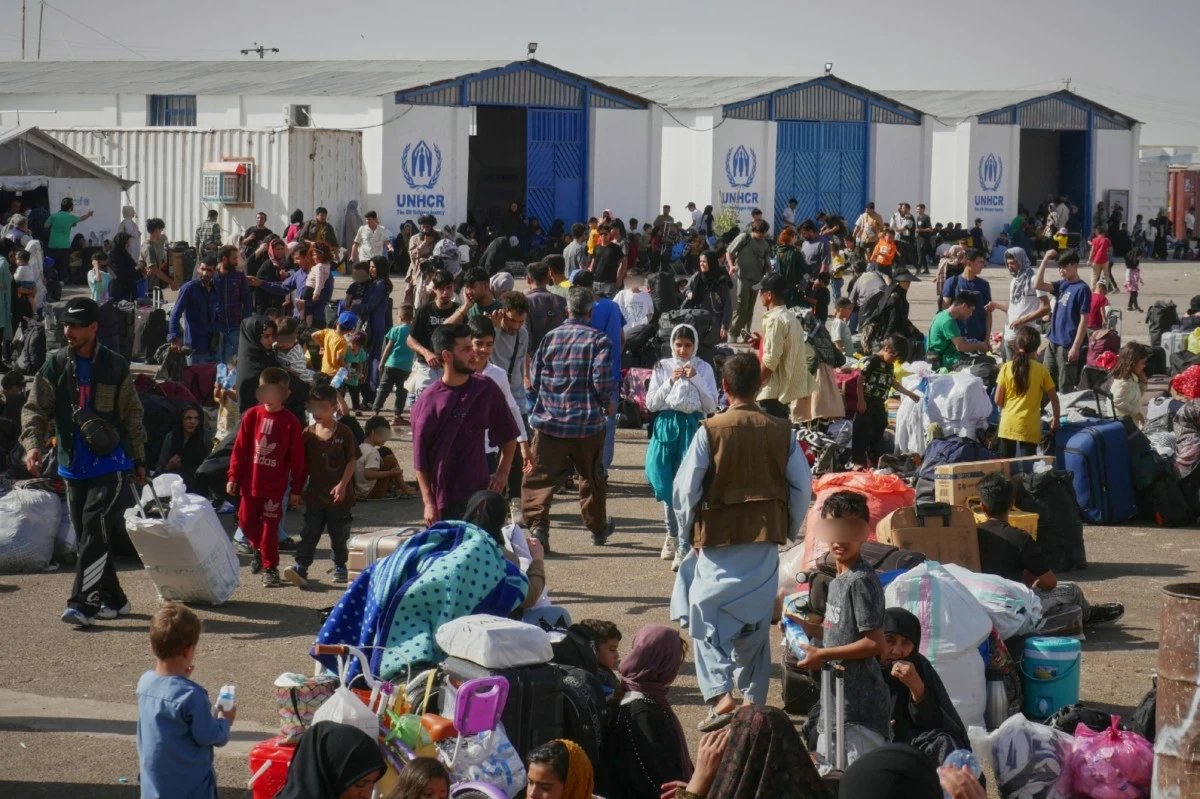 Afghan refugees who returned after fleeing Iran to escape deportation and conflict gather at a UNHCR facility near the Islam Qala crossing in western Herat province, Afghanistan, on Friday, June 20, 2025. (AP Photo/Omid Haqjoo)