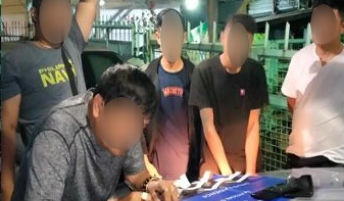 The Taguig police with the suspect (Photo from Taguig police / SPD)