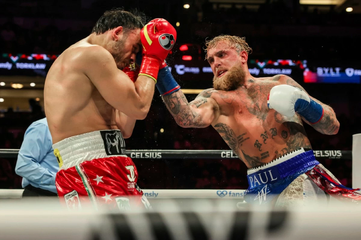 Jake Paul, right, punches Julio Cesar Chavez Jr. during their cruiserweight boxing match on Saturday, June 28, 2025, in Anaheim, Calif. (AP Photo/Etienne Laurent)