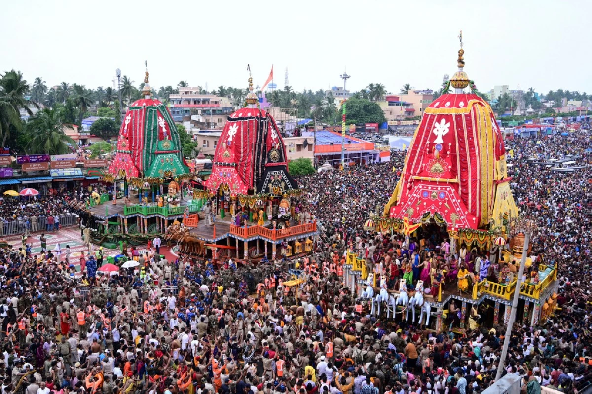 Hindu devotees walk in a procession accompanying three large chariots housing deities, in Puri, India, Saturday, June 28, 2025. (AP Photo)