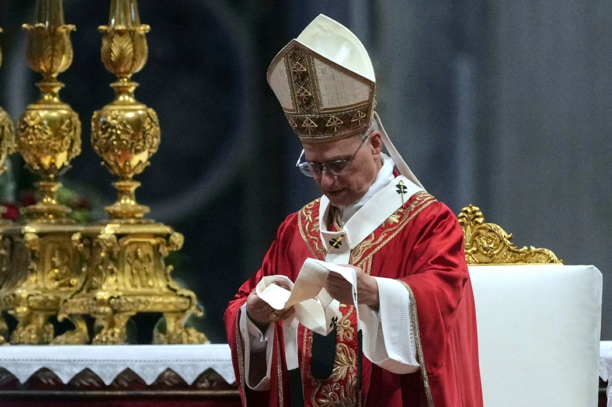 Pope Leo XIV look at a pallium, he blessed for the new metropolitan archbishops during a Mass in St. Peter's Basilica at the Vatican, Sunday, June 29, 2025. (AP Photo/Andrew Medichini)