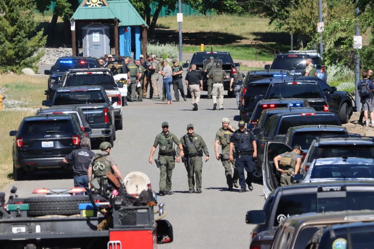 Law enforcement and emergency responders at Cherry Hill Park off 15th Street on Sunday afternoon, June 29, 2025, following reports of an ambush shooting attack on Canfield Mountain, in Coeur d'Alene, Idaho. (Bill Buley/Coeur D'Alene Press via AP)