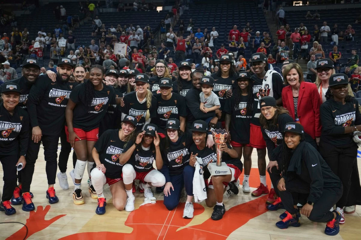 Indiana Fever players celebrate after winning the WNBA Commissioner's Cup championship basketball game against the Minnesota Lynx, Tuesday, July 1, in Minneapolis. (AP Photo/Abbie Parr)