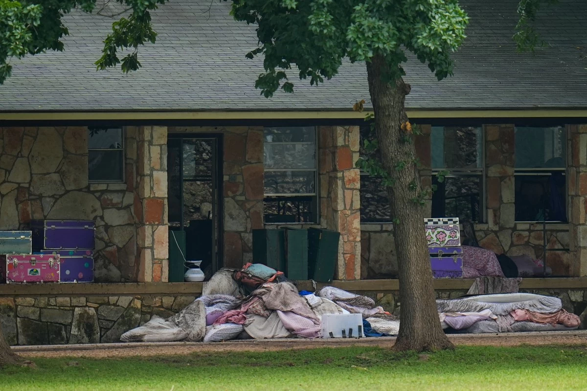 Bedding items are seen outside sleeping quarters at Camp Mystic along the banks of the Guadalupe River after a flash flood swept through the area Saturday, July 5, 2025, in Hunt, Texas. (AP Photo/Julio Cortez)