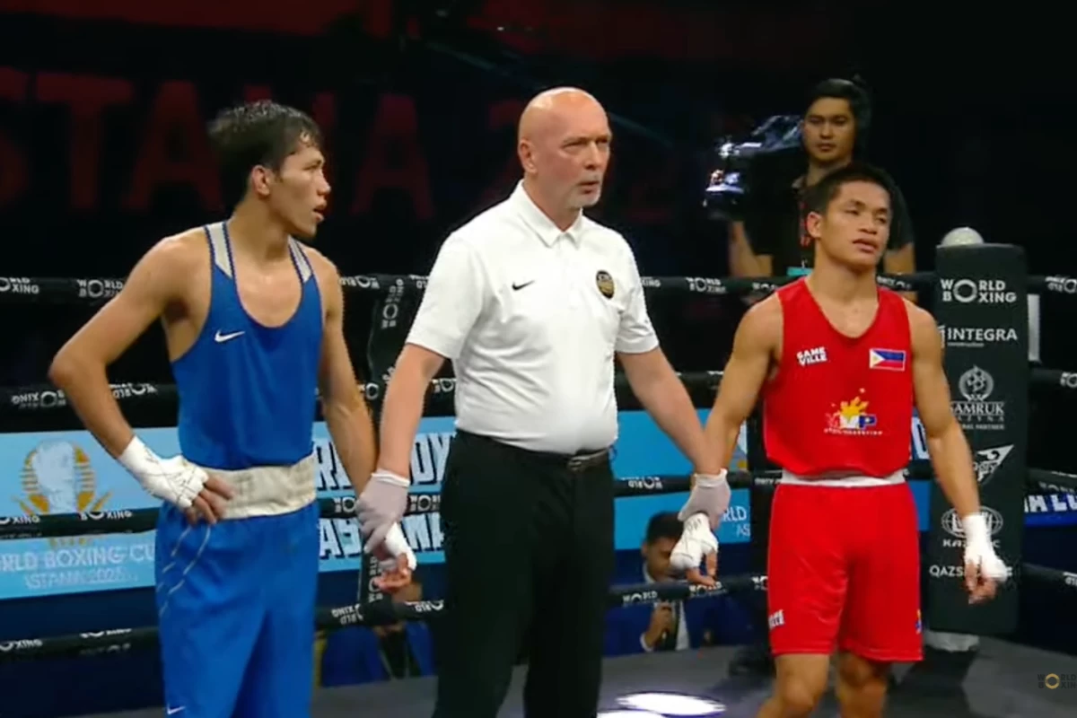Jay Bryan Baricuatro, right, pockets the silver medal after losing in the men's 50kg final. (Screengrab from tournament livestream)