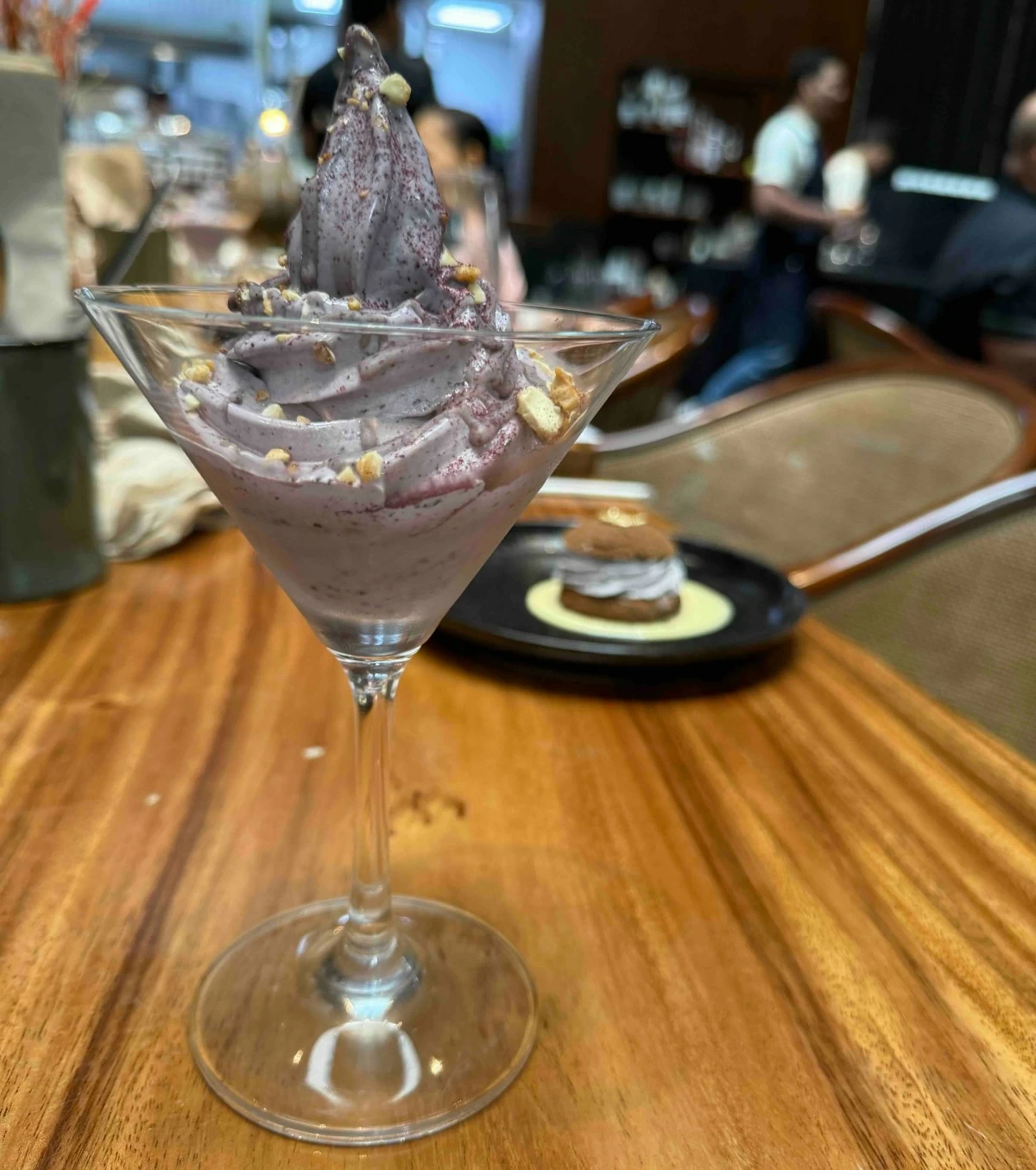 BERRY BLISS US Blueberry soft serve ice cream with blueberry chocolate stracciatella (foreground) and chocolate profiteroles with US blueberry diplomat cream and vanilla cream sauce (background) were sweet ways to end the meal.