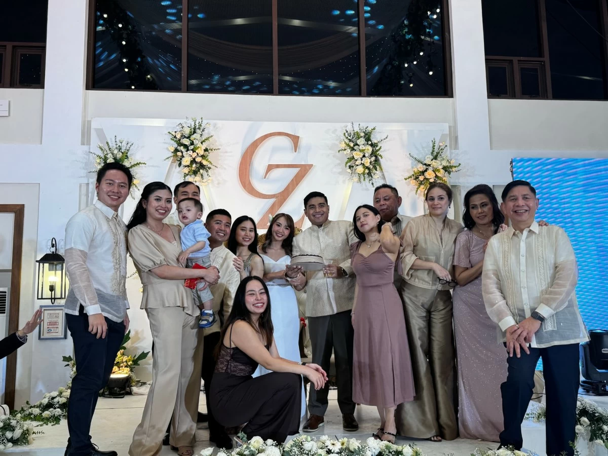 The Sy family surprises Christopher with a birthday cake.