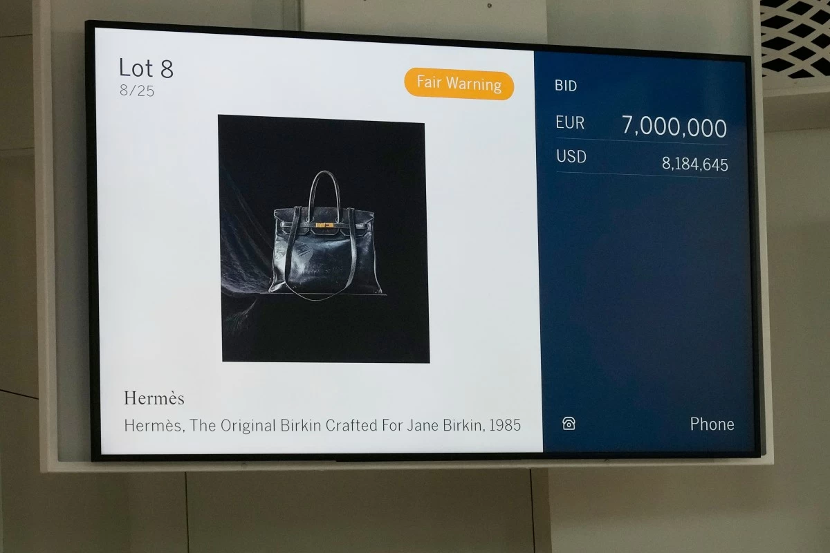 An electronic board shows the bid after the original Birkin bag created by Hermès for Jane Birkin was sold at auction for 7 million euros or $8.2 million, Thursday, July 10, 2025 in Paris. (AP Photo/Michel Euler)