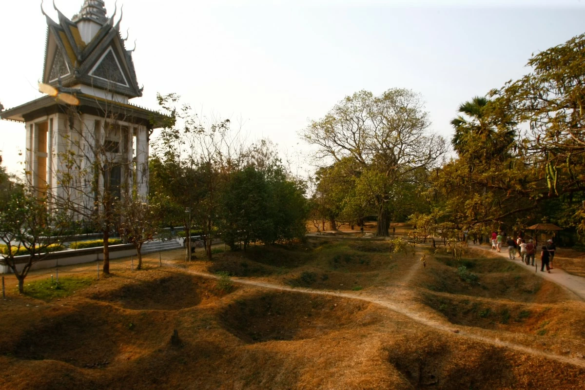 VISITORS walk by the mass grave of the victims of the Khmer Rouge regime next to a memorial stupa filled with victims' skulls at the Choeung Ek killing field in Phnom Penh, Cambodia, Wednesday, Feb. 19, 2014. (AP file photo)