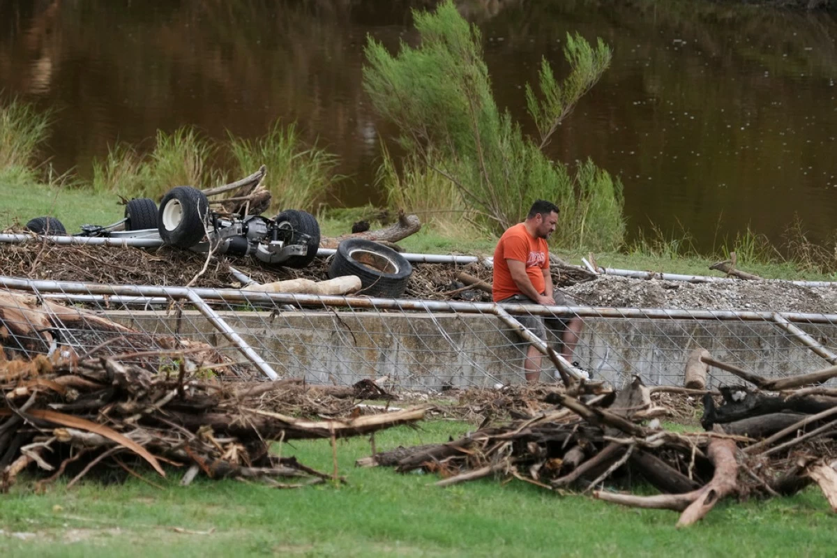 A man surveys debris and flood damage along the Guadalupe River, Sunday, July 13, 2025, in Kerrville, Texas. (AP Photo/Eric Gay)