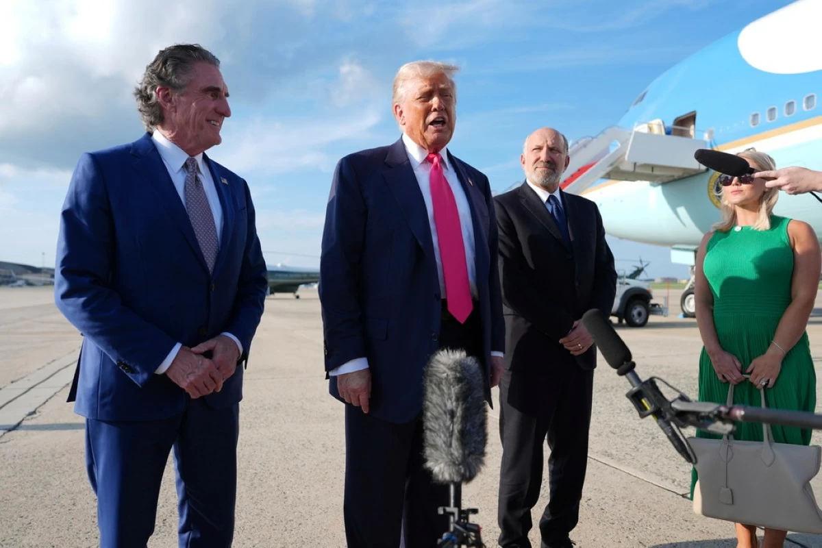 President Donald Trump speaks to the media after arriving at Joint Base Andrews, Tuesday, July 15, 2025, in Joint Base Andrews, Md., as Secretary of the Interior Doug Burgum, left, Secretary of Commerce Howard Lutnick and White House Press Secretary Karoline Leavitt, right, look on. (AP Photo/Evan Vucci)