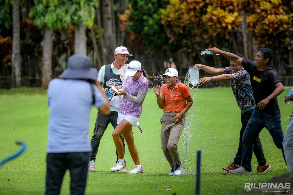 Cousins AJ Wacan and Merry Rose Wacan each receive a celebratory victory splash after clinching wins in contrasting styles.