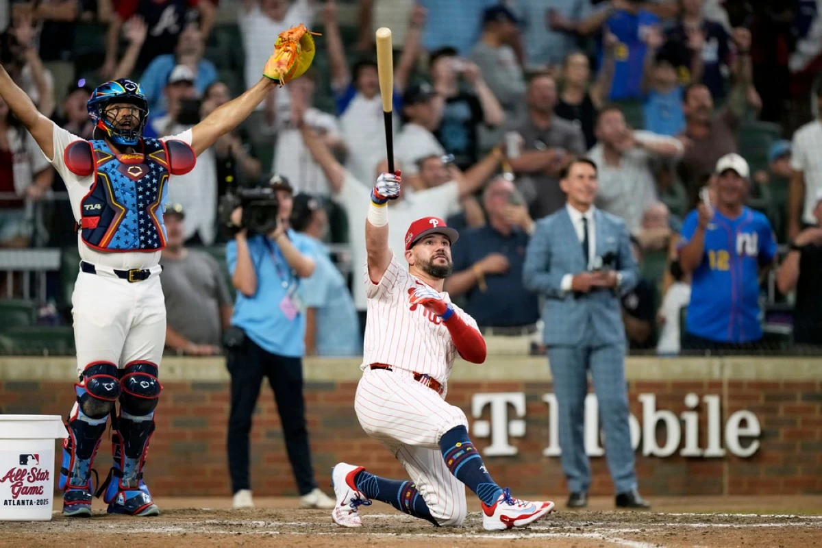 Philadelphia Phillies Kyle Schwarber celebrates after winning the tiebreaker at the MLB baseball All-Star game between the American League and National League, Tuesday, July 15, 2025, in Atlanta. (AP Photo/Brynn Anderson)