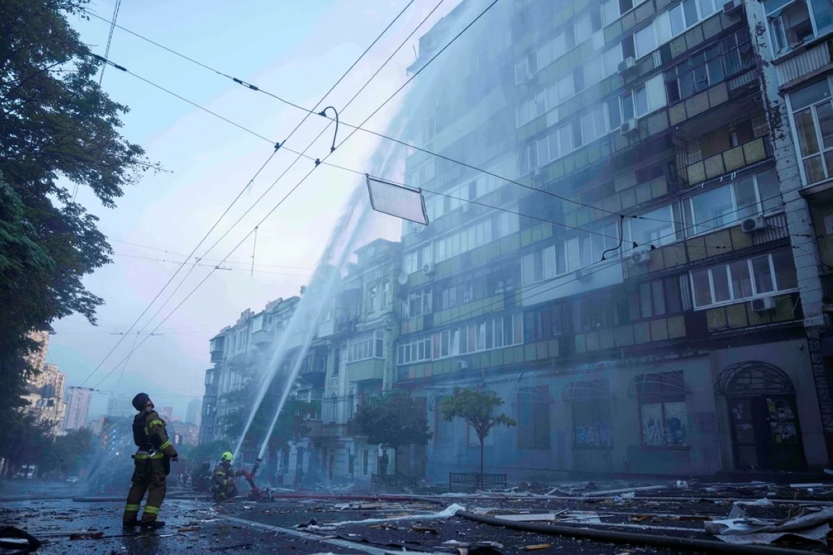 FILE - Rescue workers try to put out a fire at an apartment building heavily damaged by a Russian strike in Kyiv, Ukraine, on July 10, 2025. (AP Photo/Evgeniy Maloletka, File)