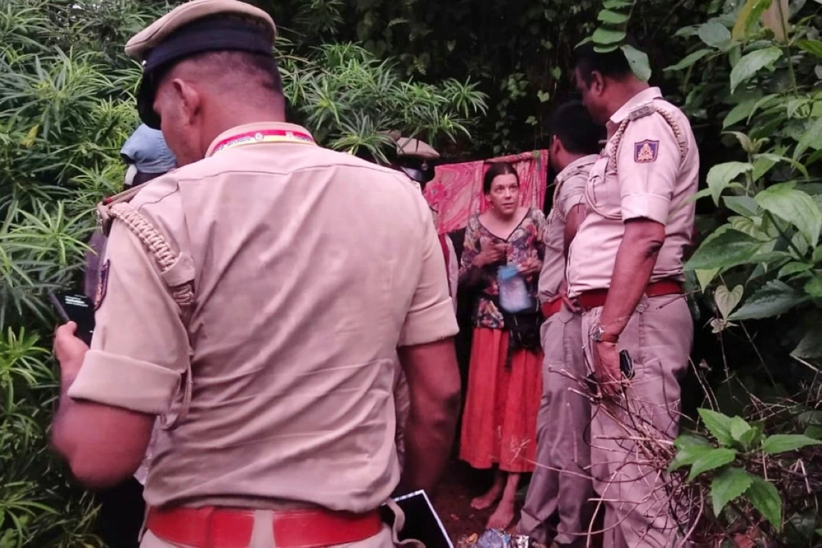 Indian policemen rescue Nina Kutina, 40, a Russian woman, from a cave in forest area of Ramtirtha hills in southern Indian state of Karnataka, Wednesday, July 9, 2025. (Uttara Kannada District Police via AP)