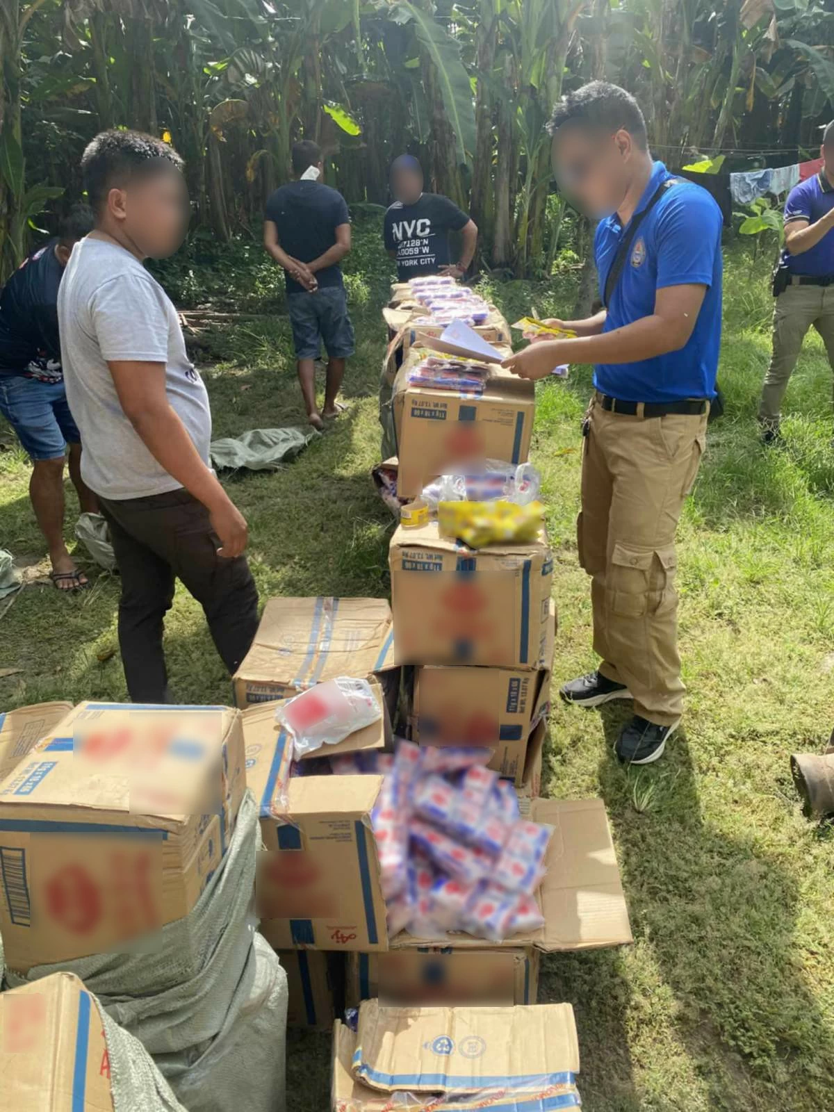 CIDG operatives inspect the alleged fake seasoning products seized during a raid in Digos City. (photo: CIDG)