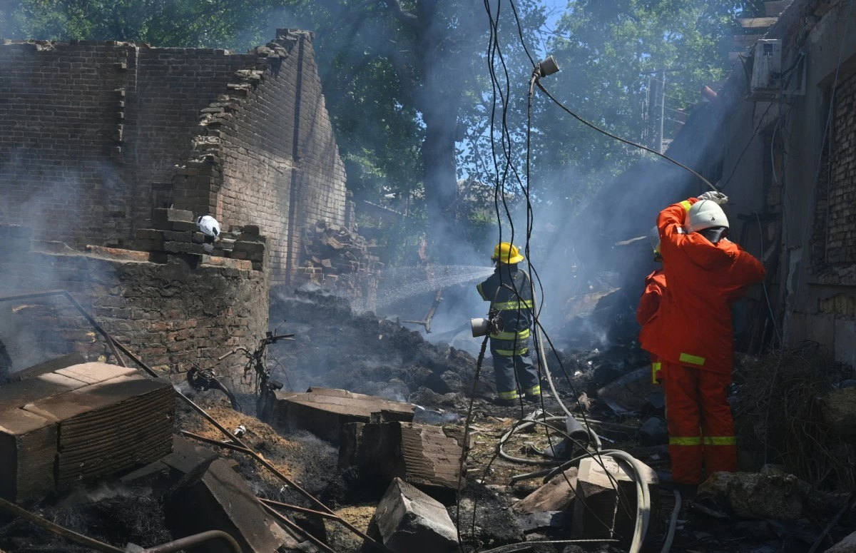 Emergency services personnel work to extinguish a fire following a Russian attack in Odesa, Ukraine, Friday, July 11, 2025. (AP Photo/Michael Shtekel)