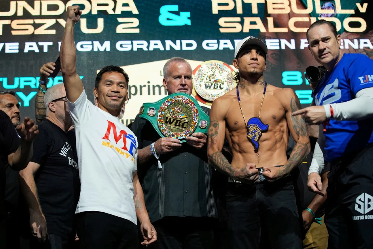 Manny Pacquiao, left, and WBC welterweight champion Mario Barrios pose at a ceremonial weigh in Friday, July 18, 2025, in Las Vegas. (AP Photo/John Locher)