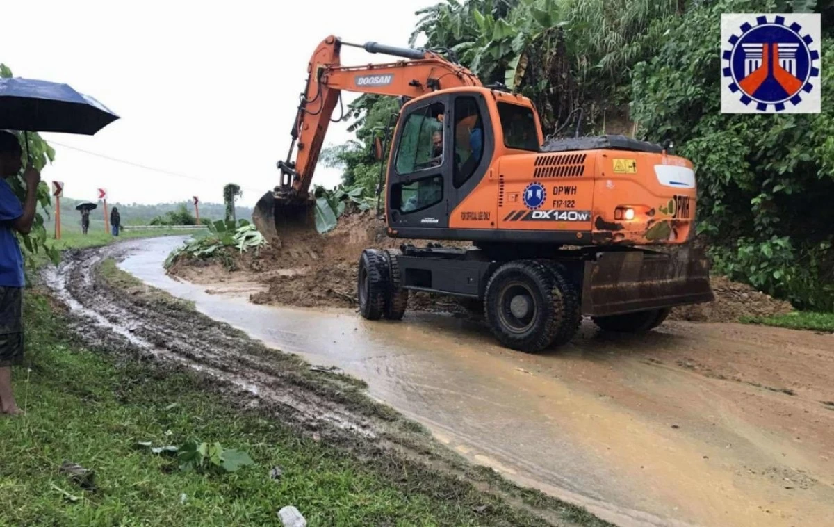DPWH workers inspect a flooded segment of Bacolod South Road in Barangay Dancalan, Ilog, Negros Occidental, on Friday, July 19, amid heavy rains brought by tropical storm “Crising” and the southwest monsoon. The road remains accessible only to heavy vehicles. (Photo from DPWH)