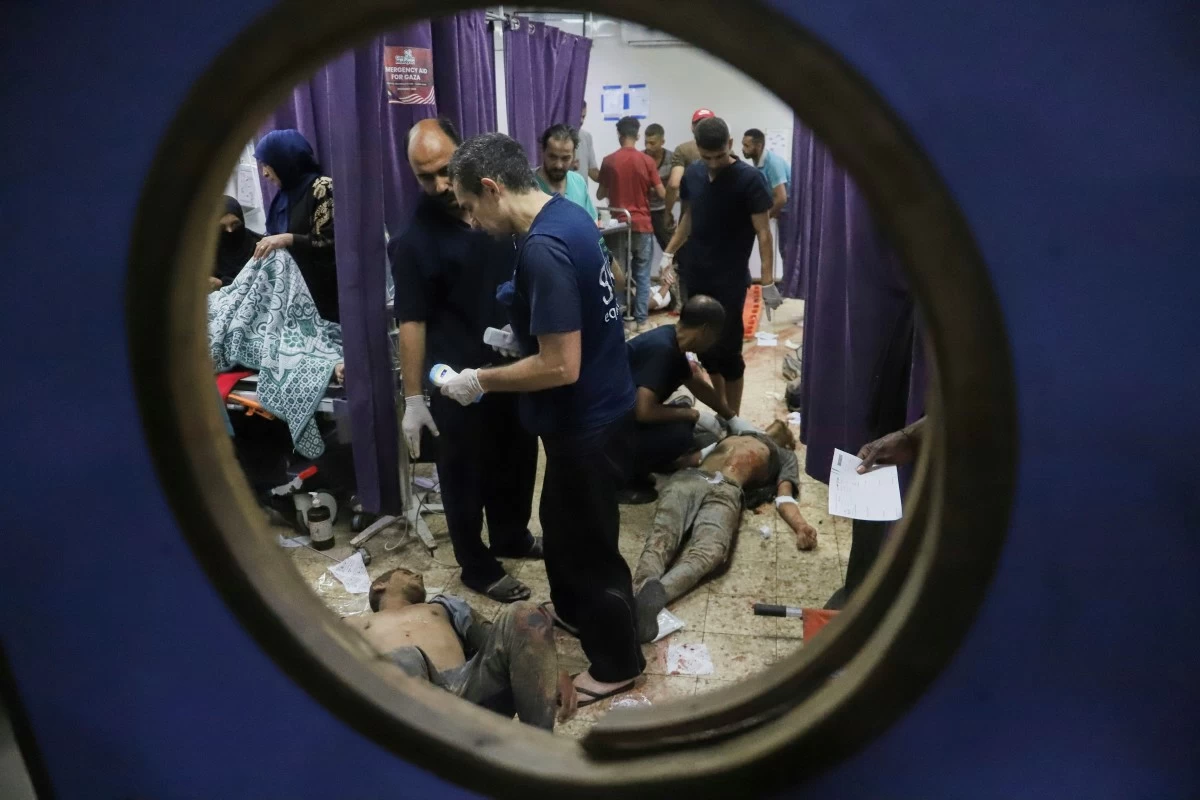 Palestinians who were injured during a food distribution at a center run by the Gaza Humanitarian Foundation, a U.S.-backed organization approved by Israel, receive treatment on the floor of Nasser Hospital in Khan Younis, southern Gaza Strip, Saturday, July 19, 2025. (AP Photo/Mariam Dagga)