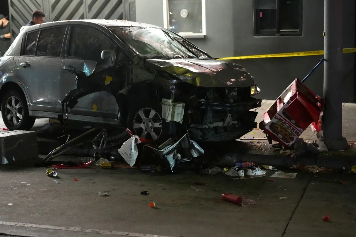 A vehicle sits on the sidewalk after ramming into a crowd of people waiting to enter a nightclub along a busy boulevard in Los Angeles early Saturday, July 19, 2025 injuring several people. (AP Photo/Damian Dovarganes)