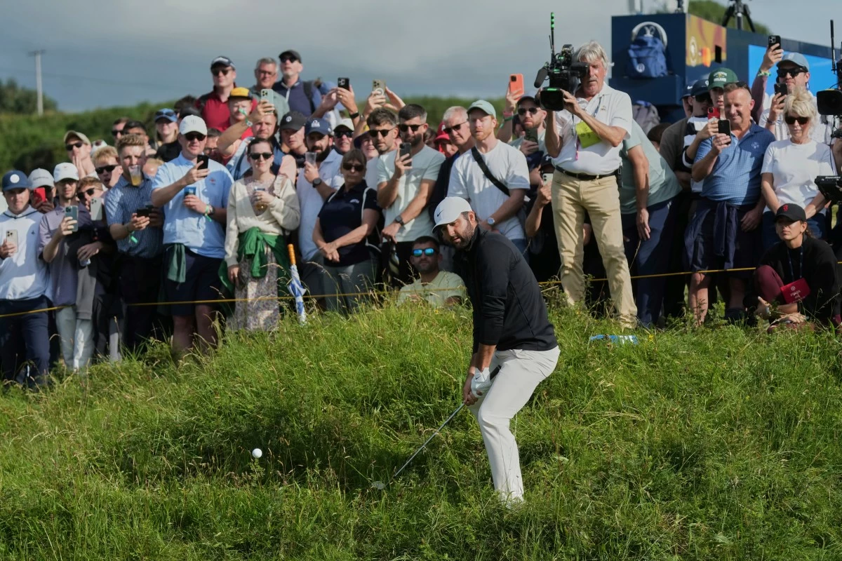 Scottie Scheffler of the United States plays out of the rough on the 11th green during the third round of the British Open golf championship at the Royal Portrush Golf Club, Northern Ireland, Saturday, July 19, 2025. (AP Photo/Jon Super)