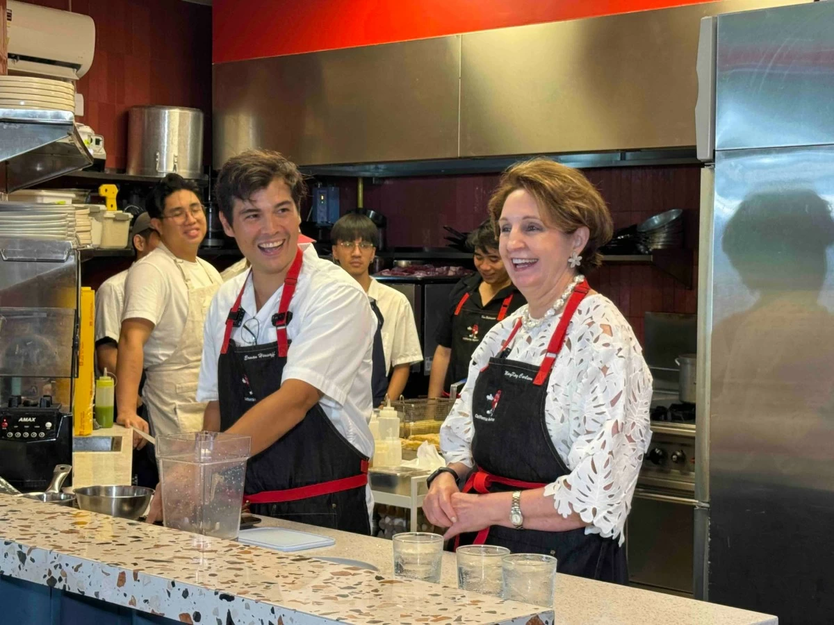 Heussaff and Ambassador Carlson share a light moment in the kitchen while preparing their featured dishes.
