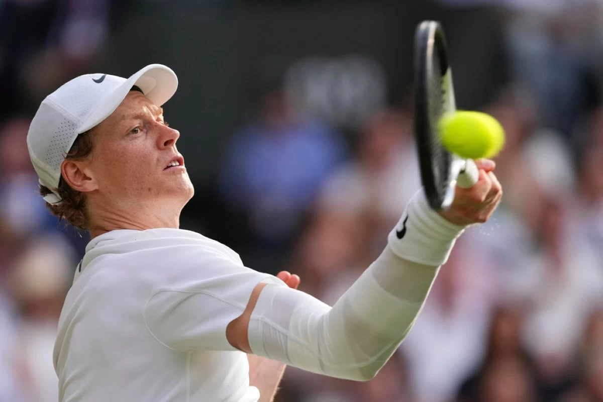 Jannik Sinner of Italy plays a return to Carlos Alcaraz of Spain during the men's singles final match at the Wimbledon Tennis Championships in London, Sunday, July 13, 2025.(AP Photo/Kirsty Wigglesworth)