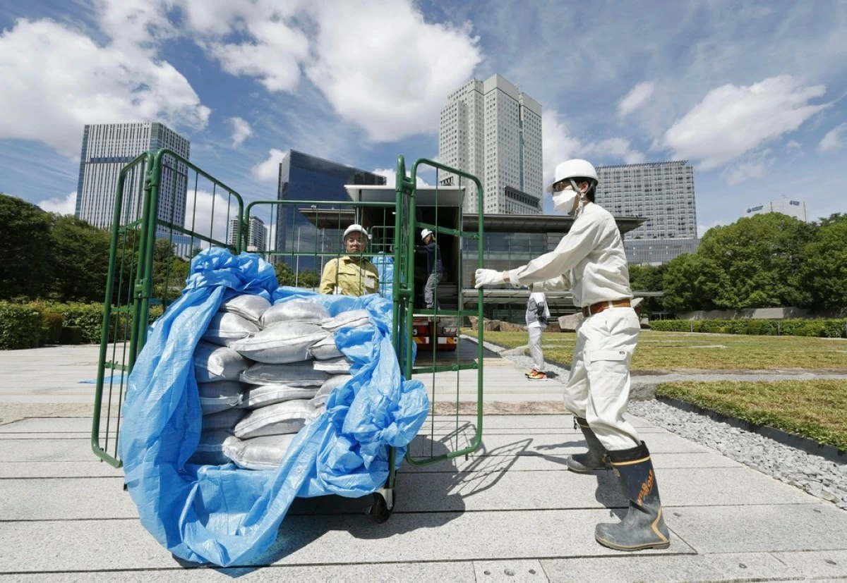 Bags of soil, decontaminated but slightly radioactive one from Fukushima, are delivered to the Japanese prime minister's office to be reused in the garden, in Tokyo, Japan, Saturday, July 19, 2025. (Kyodo News via AP)