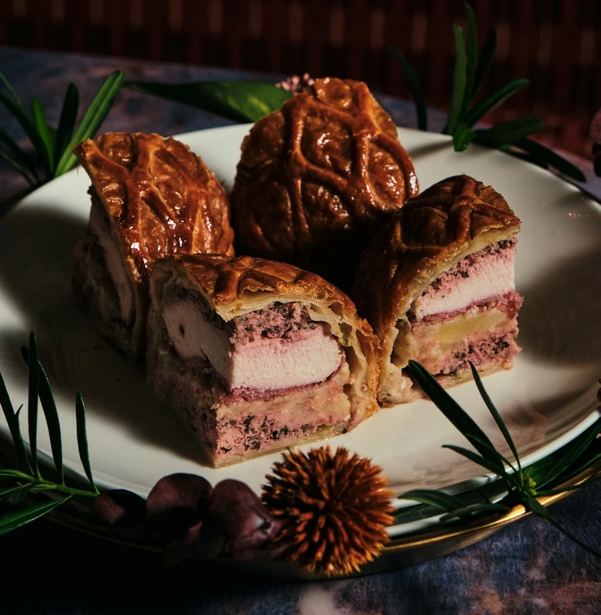 LAYERED LUXURY Medusa’s Chicken Wellington arrives sealed in crisp pastry, the center still tender and blushing pink.